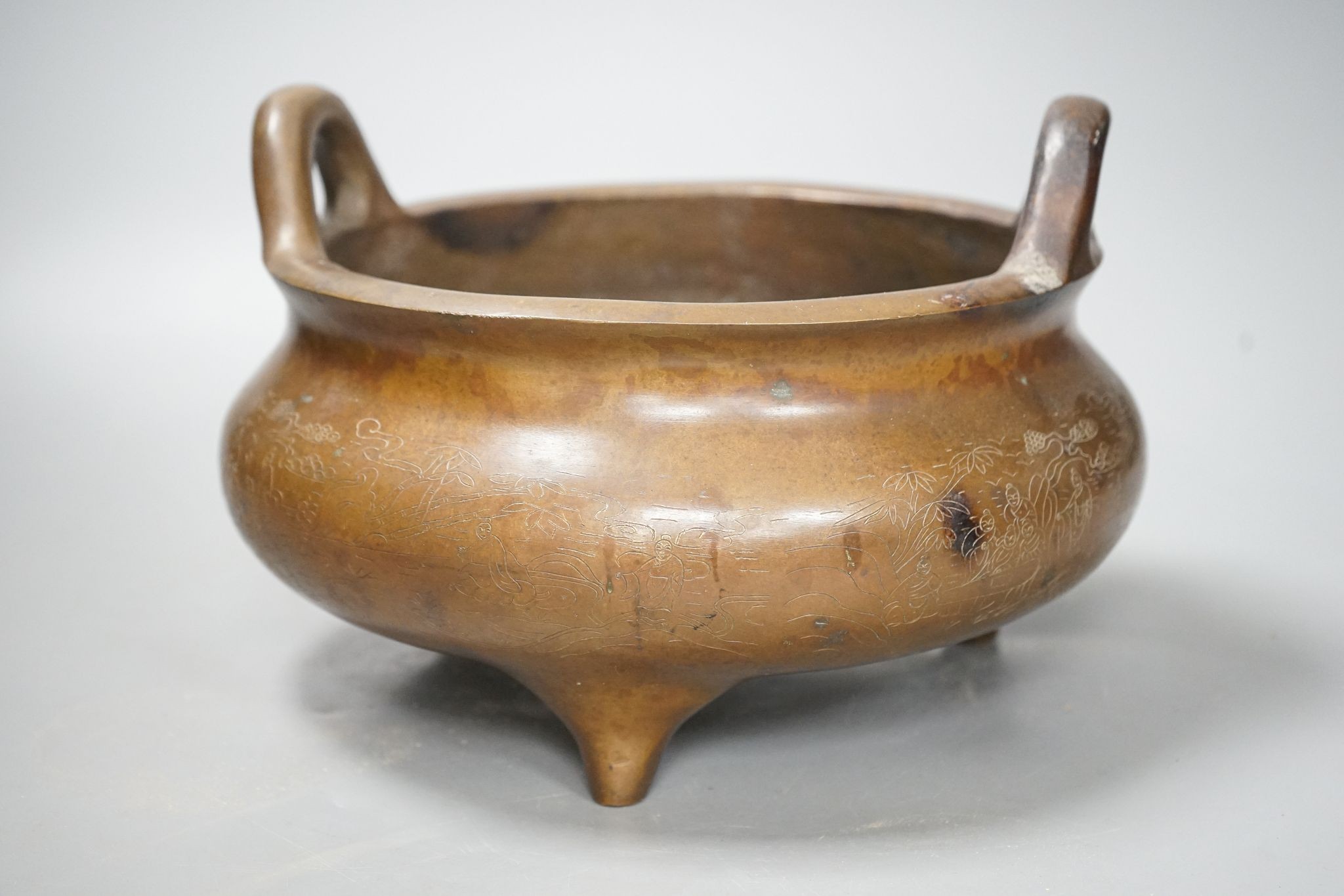 A large Chinese bronze tripod censer, Xuande mark, 24cm handle to handle